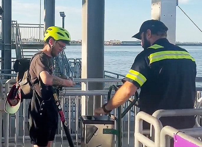 ferry employees helping riders